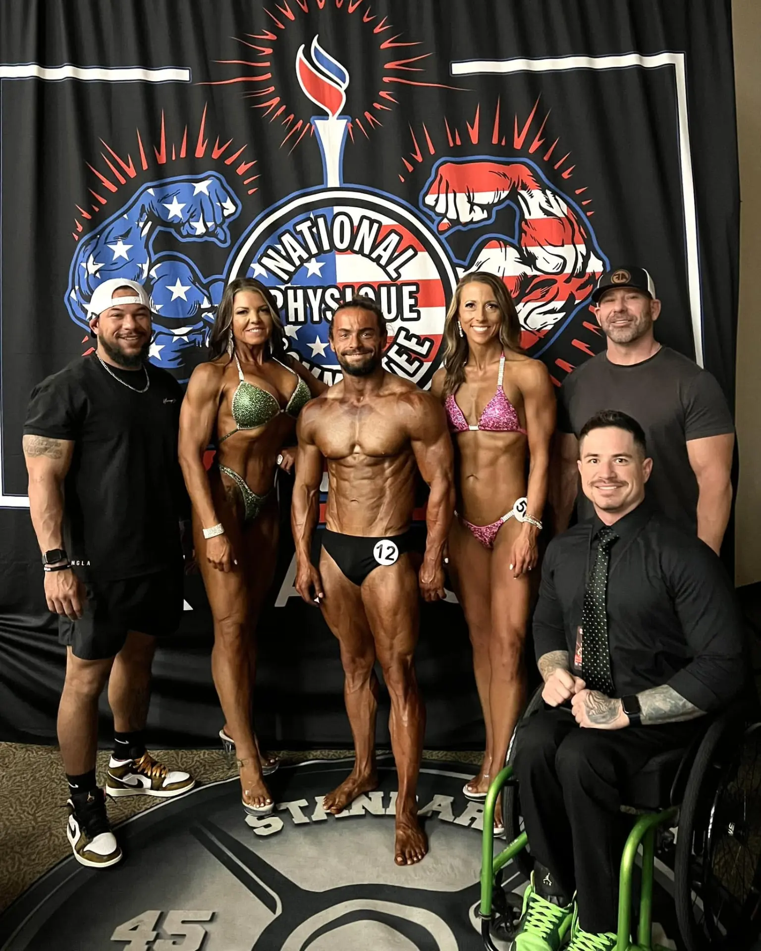 Brink Physiques athletes and coaches at an NPC physique competition