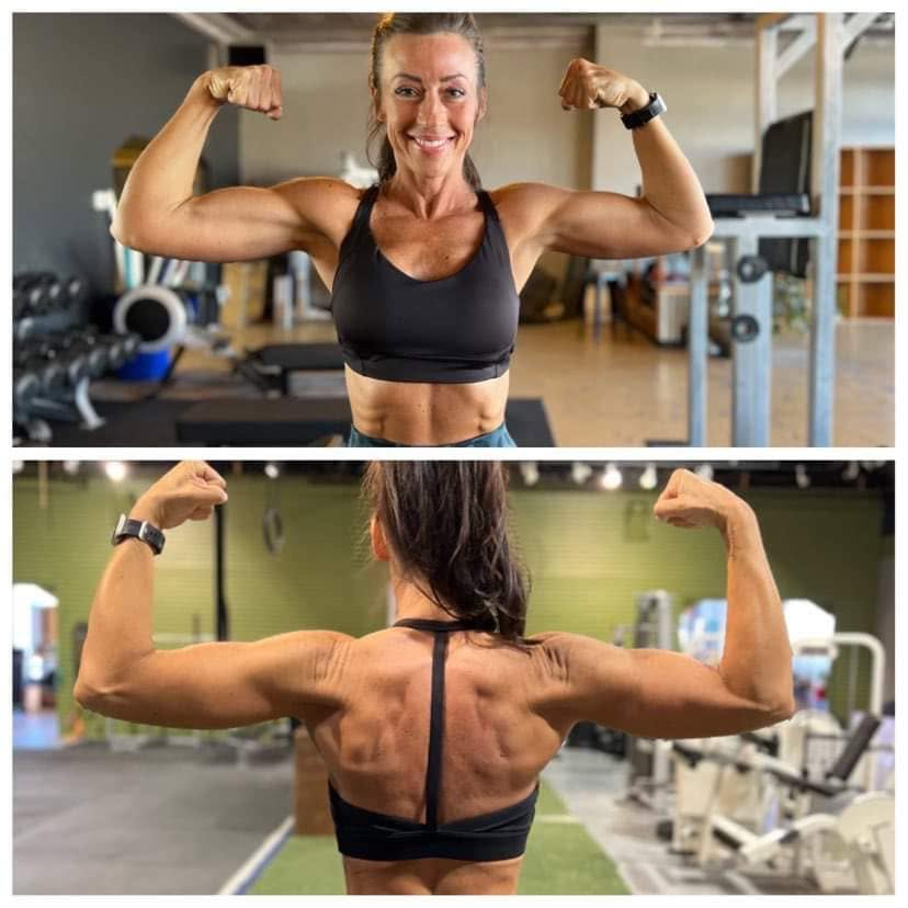 Female client double biceps poses in the gym showing developed arms and back