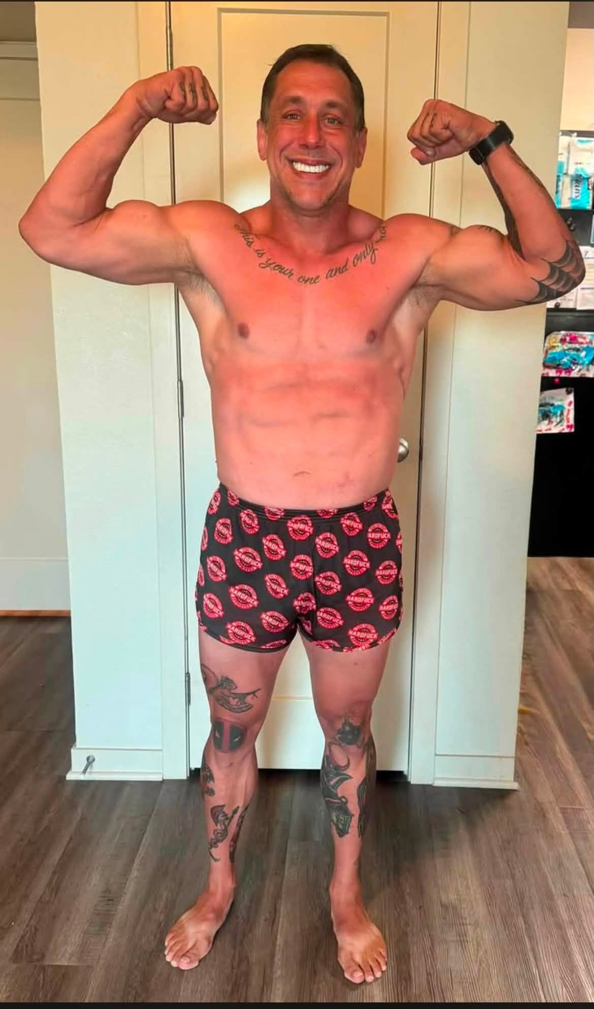 James Berger one year later, leaner and more conditioned, hitting a double-biceps pose